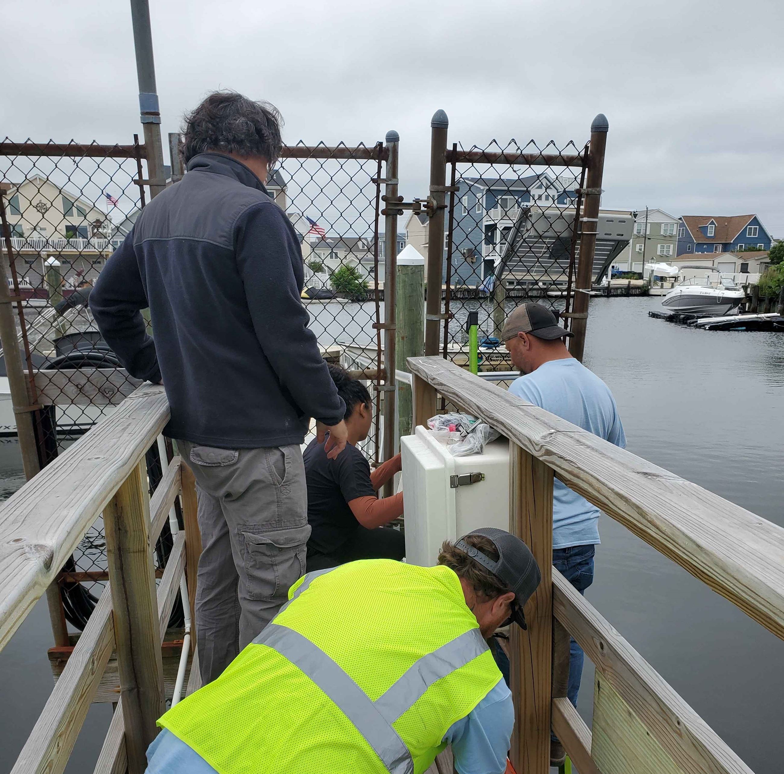 Dr. Montalto & Dr. Shakya install the tide gauge with assistance from Stafford DWP department. 